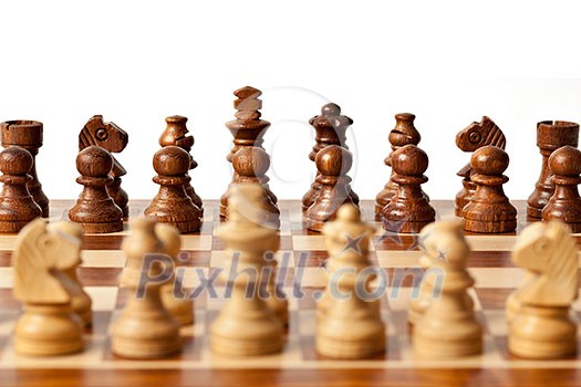 Wooden chess pieces on chessboard. Selective focus, shallow depth of field Wooden chess pieces on chessboard. Selective focus, shallow depth of field