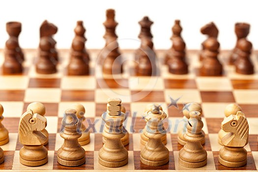 Wooden chess pieces on chessboard. Selective focus, shallow depth of field Wooden chess pieces on chessboard. Selective focus, shallow depth of field