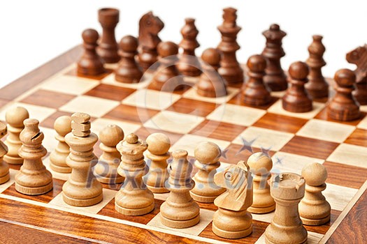 Wooden chess pieces on chessboard. Selective focus, shallow depth of field Wooden chess pieces on chessboard. Selective focus, shallow depth of field