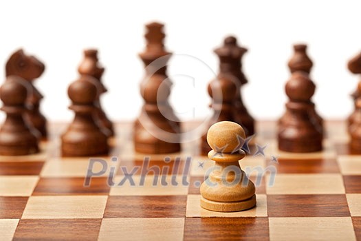 One pawn agains all - wooden chess pieces on chessboard. Selective focus, shallow depth of field One pawn agains all - wooden chess pieces on chessboard. Selective focus, shallow depth of field