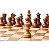 One king agains all - wooden chess pieces on chessboard. Selective focus, shallow depth of field