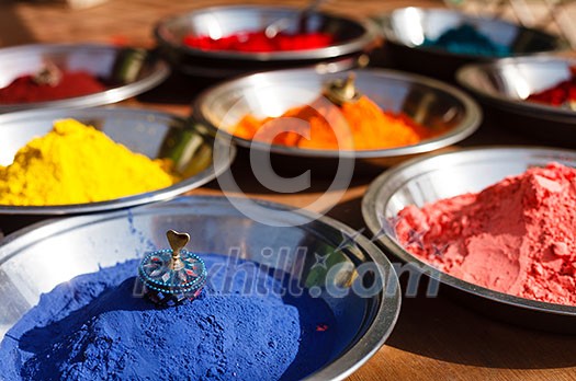 India symbol. Colored colorful powder kumkum in bowls on Indian bazaar for Holi and other festivals celebration India symbol. Colored colorful powder kumkum in bowls on Indian bazaar for Holi and other festivals celebration