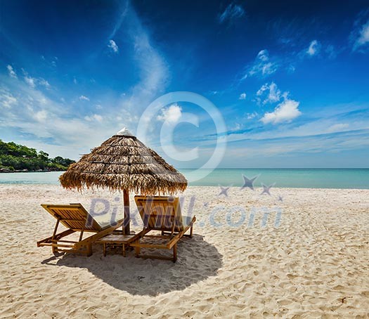 Two beach lounge chairs under tent on beach. Sihanoukville, Cambodia Two beach lounge chairs under tent on beach. Sihanoukville, Cambodia