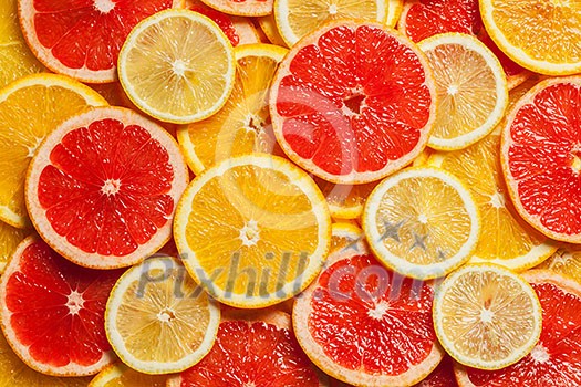 Colorful citrus fruit - lemon, orange, grapefruit - slices background Colorful citrus fruit - lemon, orange, grapefruit - slices background