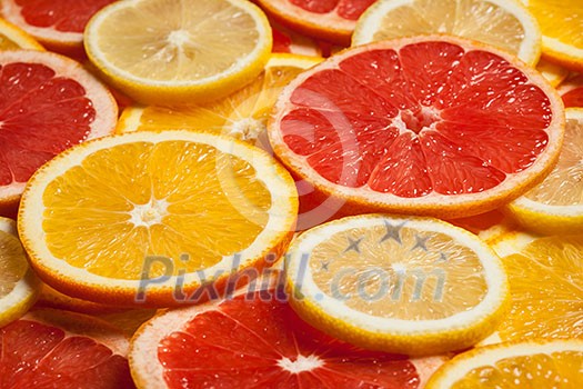 Colorful citrus fruit - lemon, orange, grapefruit - slices background Colorful citrus fruit - lemon, orange, grapefruit - slices background