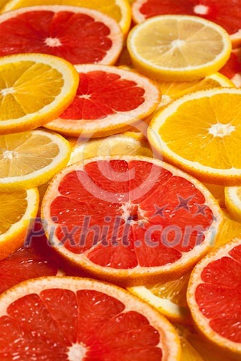 Colorful citrus fruit - lemon, orange, grapefruit - slices background Colorful citrus fruit - lemon, orange, grapefruit - slices background