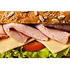 Ham sandwich with lettuce, cheese, tomato close up