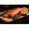 Fresh salmon piece on wooden cooking board with vegetables