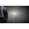 Chest view of businessman against cement wall