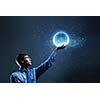 Young man in suit holding moon in palm