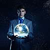 Young businessman holding Earth planet in palm. Elements of this image are furnished by NASA