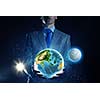 Young businessman holding Earth planet in palm. Elements of this image are furnished by NASA