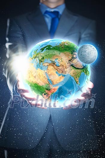 Young businessman holding Earth planet in palm. Elements of this image are furnished by NASA Young businessman holding Earth planet in palm. Elements of this image are furnished by NASA