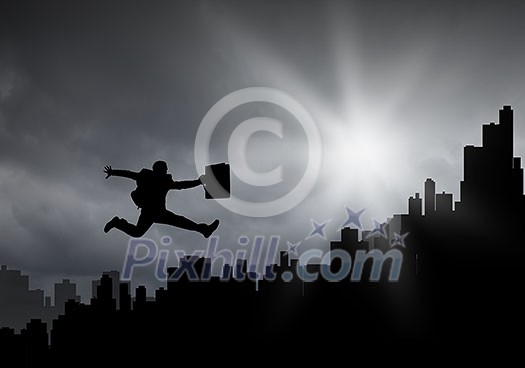 Silhouette of businessman jumping against sunset background Silhouette of businessman jumping against sunset background