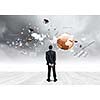 Back view of confident businessman looking at items flying in air