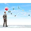 Back view of confident businessman looking at items flying in air