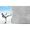 Businessman breaking stone wall with karate kick