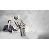 Angry young businessman fighting with stone opponent
