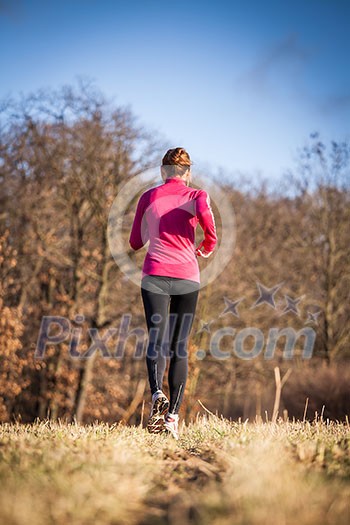 Young woman running outdoors on a lovely sunny winter/fall day Young woman running outdoors on a lovely sunny winter/fall day