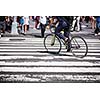 Man on a bike on a crossing in Manhattan, NYC