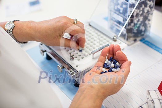 medical pills industry factory and production indoor, worker's hands handling pills