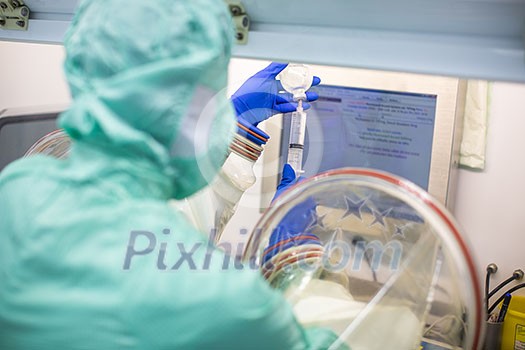 Work in super clean lab environment - (shallow DOF; color toned image) Work in super clean lab environment - (shallow DOF; color toned image)