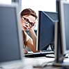 Pretty, female student looking at a desktop computer screen, learning unpleasant news about her exam results. University/office/school concept