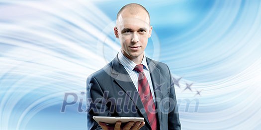 Young handsome businessman holding tablet pc in hand Young handsome businessman holding tablet pc in hand