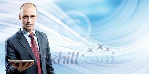 Young handsome businessman holding tablet pc in hand Young handsome businessman holding tablet pc in hand