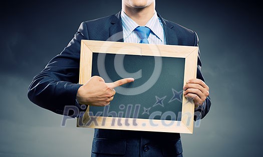 Handsome businessman holding blank frame. Place for text Handsome businessman holding blank frame. Place for text