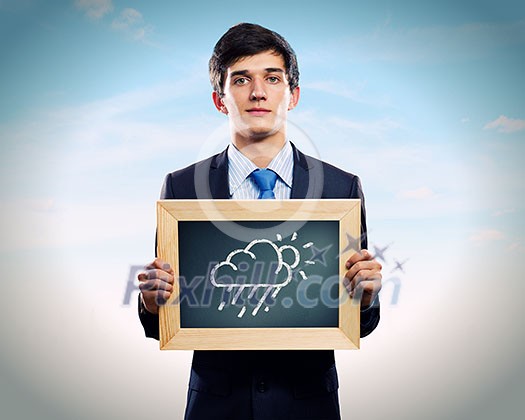 Young businessman holding frame with weather drawings Young businessman holding frame with weather drawings