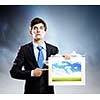 Handsome young man holding frame with pictures