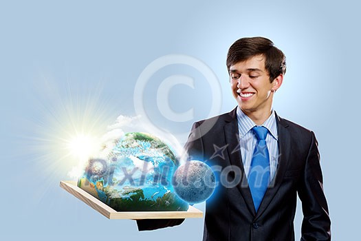 Handsome businessman holding frame with Earth planet. Elements of this image are furnished by NASA Handsome businessman holding frame with Earth planet. Elements of this image are furnished by NASA