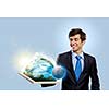 Handsome businessman holding frame with Earth planet. Elements of this image are furnished by NASA