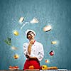 Young thoughtful cook and ingredients flying in air