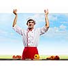 Young handsome cook holding white blank banner