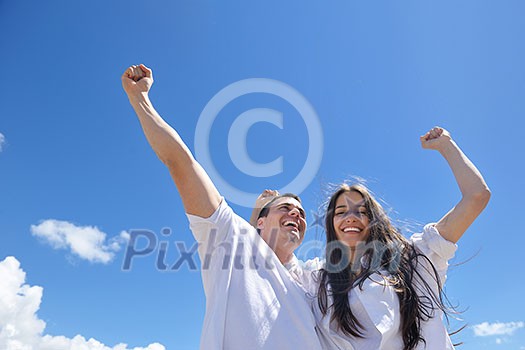 happy young couple have fun and relax  on the beach