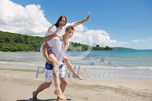happy young couple have fun and relax on the beach happy young couple have fun and relax on the beach