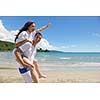 happy young couple have fun and relax  on the beach