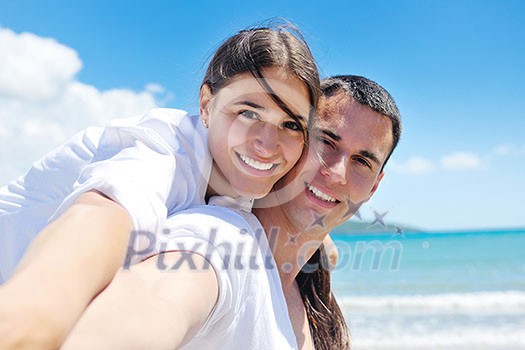 happy young couple have fun and relax on the beach happy young couple have fun and relax on the beach