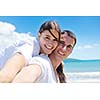 happy young couple have fun and relax  on the beach