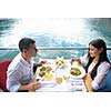 happy young couple having lanch at beautiful restaurant on by the sea on  beach
