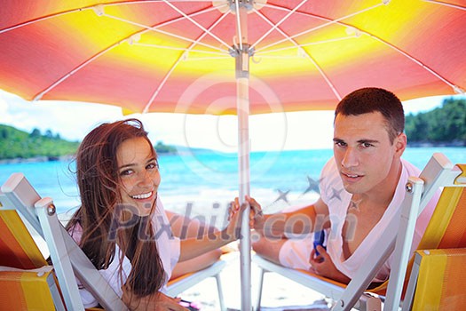 happy young couple have fun and relax on the beach happy young couple have fun and relax on the beach