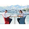 happy young couple having lanch at beautiful restaurant on by the sea on  beach