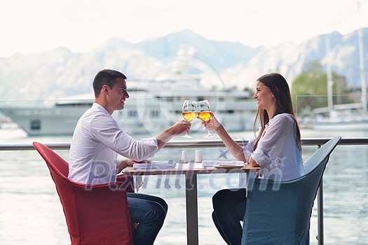 happy young couple having lanch at beautiful restaurant on by the sea on beach happy young couple having lanch at beautiful restaurant on by the sea on beach