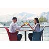 happy young couple having lanch at beautiful restaurant on by the sea on  beach