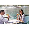 happy young couple having lanch at beautiful restaurant on by the sea on  beach