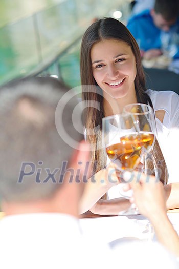 happy young couple having lanch at beautiful restaurant on by the sea on beach happy young couple having lanch at beautiful restaurant on by the sea on beach
