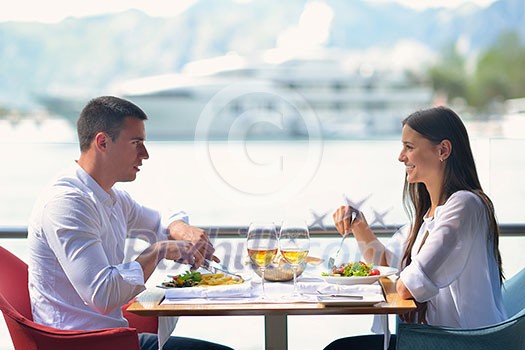 happy young couple having lanch at beautiful restaurant on the beach happy young couple having lanch at beautiful restaurant on the beach