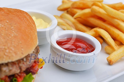 still life with fast food hamburger menu, french fries, soft drink and ketchup still life with fast food hamburger menu, french fries, soft drink and ketchup